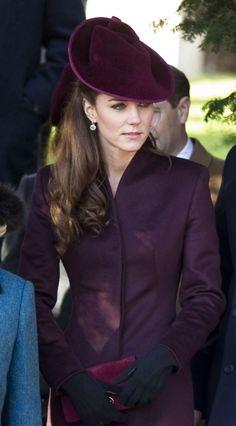 a woman in a purple coat and hat