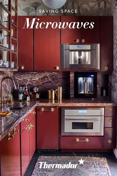 a kitchen with red cabinets and marble counter tops, an area rug and a coffee maker