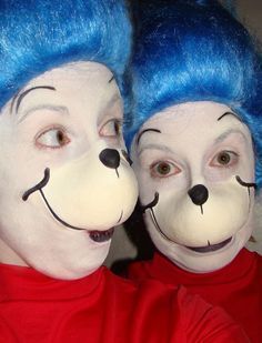 two people with blue hair and face painted like dogs