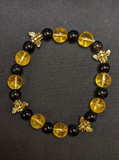 10mm yellow citrine, 8 mm black agate, small golden bee beads. Silver bee beads also available.  Very cute. I can customize it to your wrist size.  To wear: please roll a stretchy bracelet over your hand, pushing it gently on to the wrist. Pulling it may loosen the thread over time. The exact pattern of black and yellow may vary slightly based on your bracelet size. Gift box available. Bee Beads, Grey Bracelet, Gray Bracelet, Yellow Citrine, Black Agate, Stretchy Bracelets, Bracelet Sizes, Stretch Bracelet, Black N Yellow