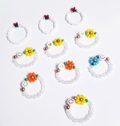 six pairs of beaded rings with flowers on them