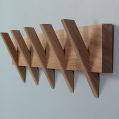 three wooden pegs are hanging on the wall