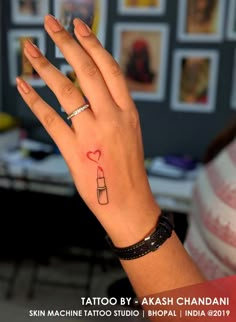 a woman's hand with a small tattoo on it