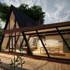 a house that is sitting on top of a wooden deck next to a building with glass windows