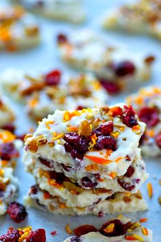 cranberry orange rice krispy treats on a baking sheet with more cookies in the background