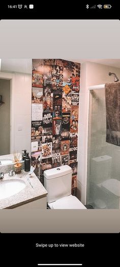 a bathroom with a toilet, sink and bathtub covered in pictures on the wall