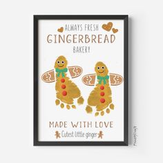 two gingerbread cookies with green bows on their heads are framed in a black frame