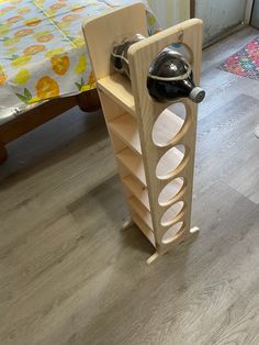 a wine rack made out of wood with a bottle on top and a glass holder in the middle