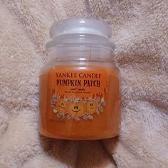 yankee candle pumpkin patch jar sitting on a blanket