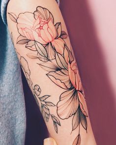 a person with a flower tattoo on their arm