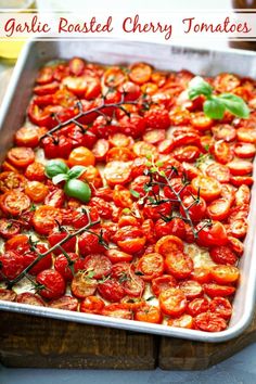 a pan filled with lots of tomatoes on top of a table