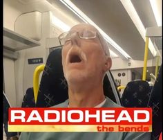 an old man with glasses is singing on the train and has his mouth wide open