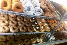 a display case filled with lots of different kinds of donuts