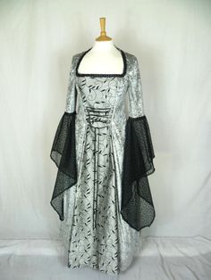 This listing is for a custom made dress,it will be made to the measurements you send me. Please send me a message with your bust ,waist and hip measurements,and please measure from the top of your shoulder to the floor with shoes on. It will be made with beautiful silver grey crushed velvet and stunning grey and black silk fabric. The sleeves are part velvet with a stunning black embroidered organza .It has a corset style front and back with lacing so you can adjust the dress to fit your body sh Black A-line Wedding Gown, Black Ball Gown With Boned Bodice, Gothic Ball Gown For Wedding, Gothic Floor-length Wedding Dress, Fitted Black Gown With Boned Bodice, Black Fitted Gown With Boned Bodice, Black Wedding Gown With Boned Bodice, Fitted Gothic Ball Gown, Floor-length Black Corset Dress For Wedding