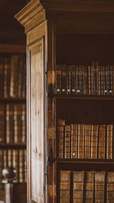 an old wooden bookcase filled with lots of books