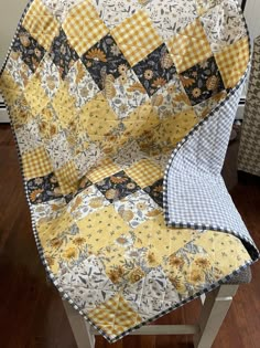 a yellow and black patchwork quilt on a chair