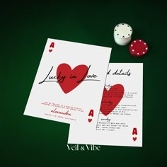 two cards with red hearts on them next to some dice and playing card game chips