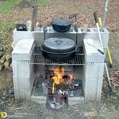 an outdoor grill with pots and pans on it