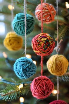 balls of yarn are hanging from a christmas tree