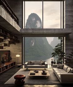 a living room filled with furniture next to a large window covered in misty mountains