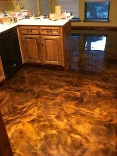 a kitchen that has been painted brown and is in the process of being polished with metallic paint