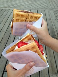 a person holding a waffle with strawberries in it and the text, recipe please i need to go find it