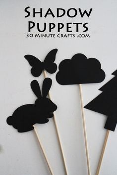 some black and white cupcake toppers are on sticks with the words shadow puppets