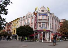 people walking in front of a mcdonald's restaurant