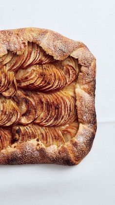 an apple pie is shown on a white surface