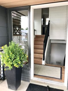 a black planter sitting in front of a door