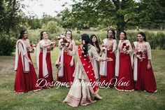 a group of women standing next to each other on top of a lush green field