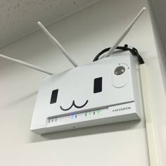 a close up of a white box with wires attached to it's face and eyes