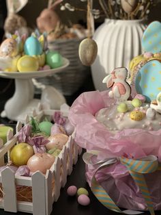 an assortment of decorated easter eggs in baskets and vases on a table with other decorations