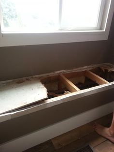 a person standing in front of a window that is being built into the side of a wall