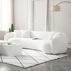 a white couch sitting on top of a wooden floor