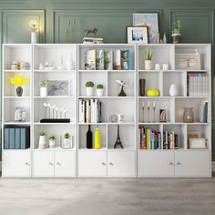 a white bookcase filled with lots of books next to a wall mounted clock and vases