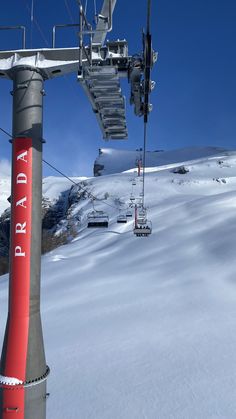 a ski lift going up the side of a snow covered mountain