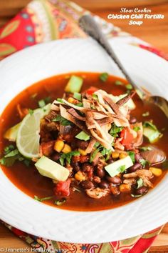 a white bowl filled with soup on top of a wooden table