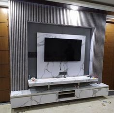 a flat screen tv sitting on top of a white entertainment center in a living room