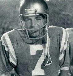 an old black and white photo of a football player wearing a helmet with the number 12 on it