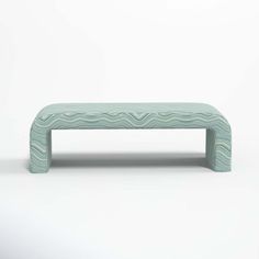 a green bench with wavy lines on it