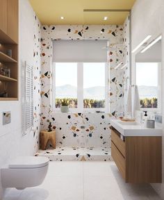 a bathroom with a toilet, sink, and window in it's wallpaper