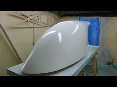 a large white surfboard sitting on top of a table