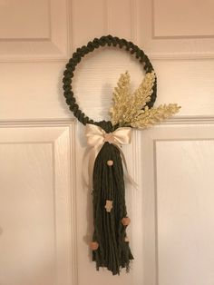 a door hanger decorated with flowers and tassels