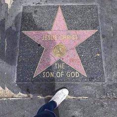 a person standing in front of a star on the hollywood walk of fame