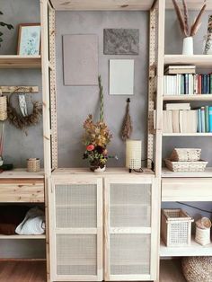 a room with shelves, baskets and other items on the shelf in front of it