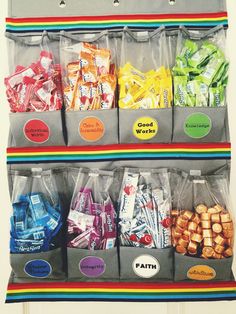 a shelf filled with lots of bags and snacks on top of each other in front of a door