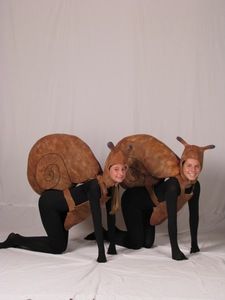 three people in costumes are posing for a photo with an antelope on their back