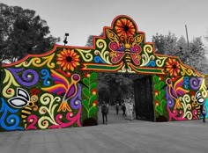 an elaborately decorated gate in the middle of a park