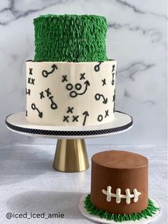 two cakes decorated with grass and footballs are on a cake stand next to each other